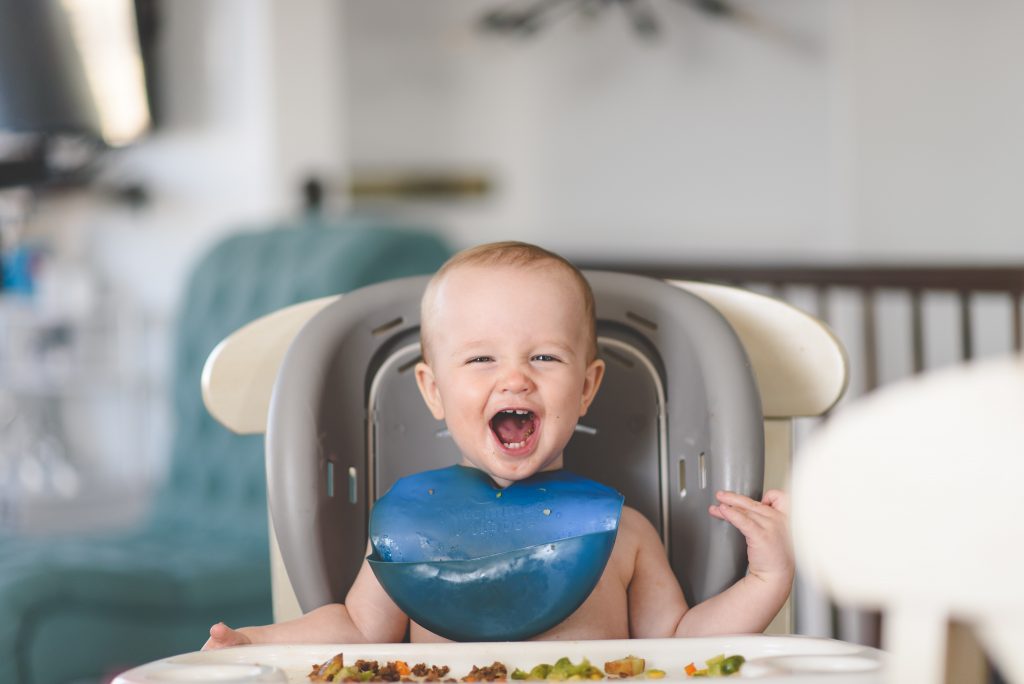 toddler sitting in high chair